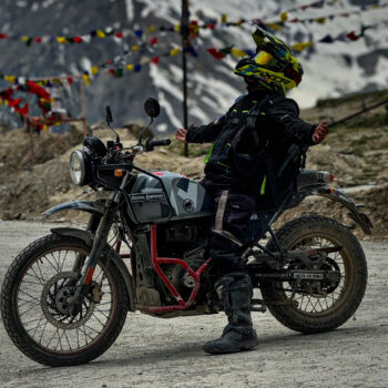 Motorcyclist riding through Kunzum Pass on the Spiti Valley Bike Tour