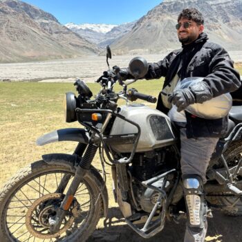 Rider on a Royal Enfield crossing a high mountain pass during Spiti Bike Tour