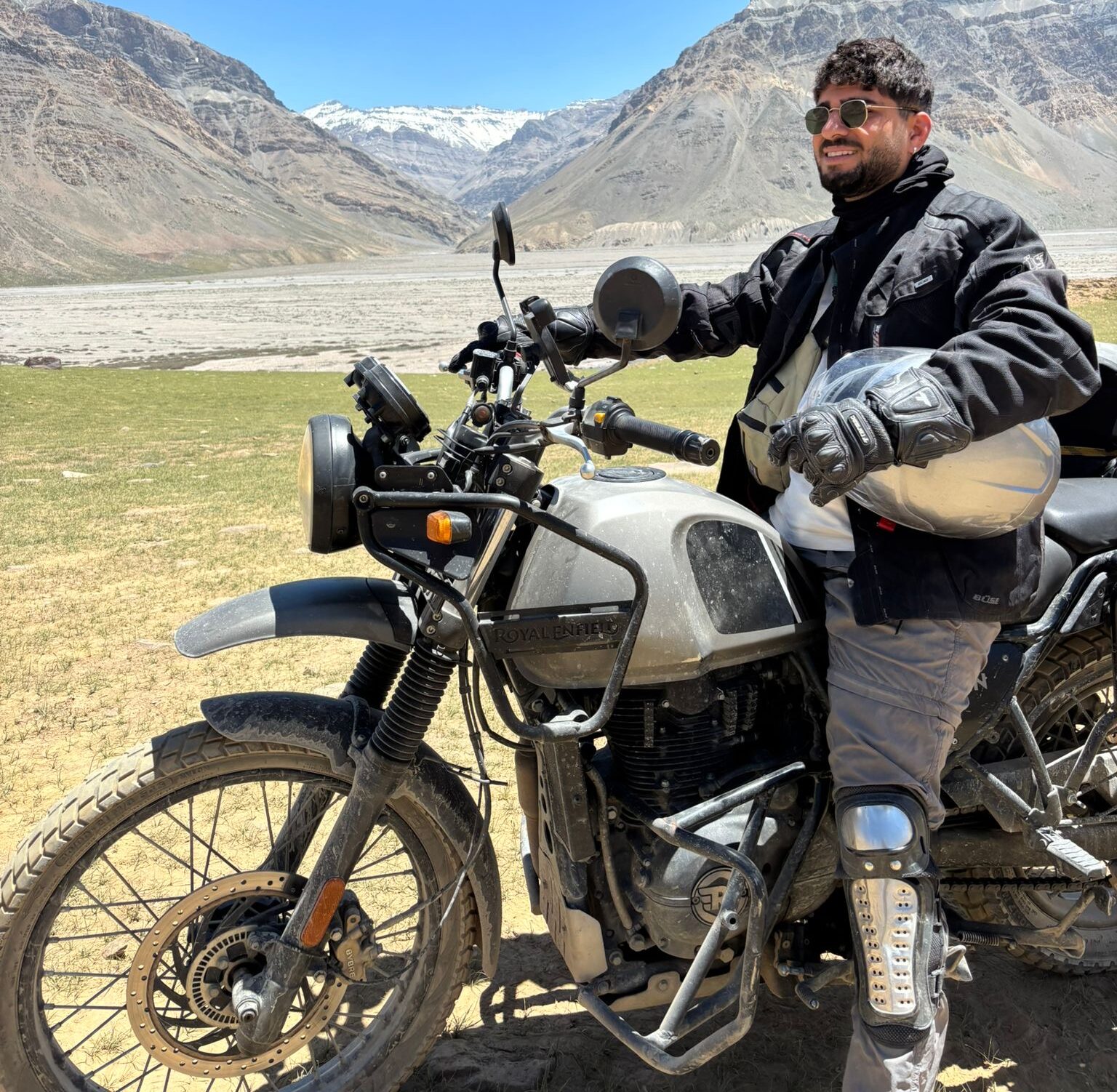 Rider on a Royal Enfield crossing a high mountain pass during Spiti Bike Tour